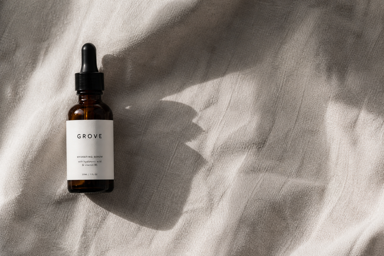 GROVE Hydrating Serum — campaign hero shot on linen